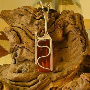 Amber pendent with sterling silver linings called Spessartine, an aura red